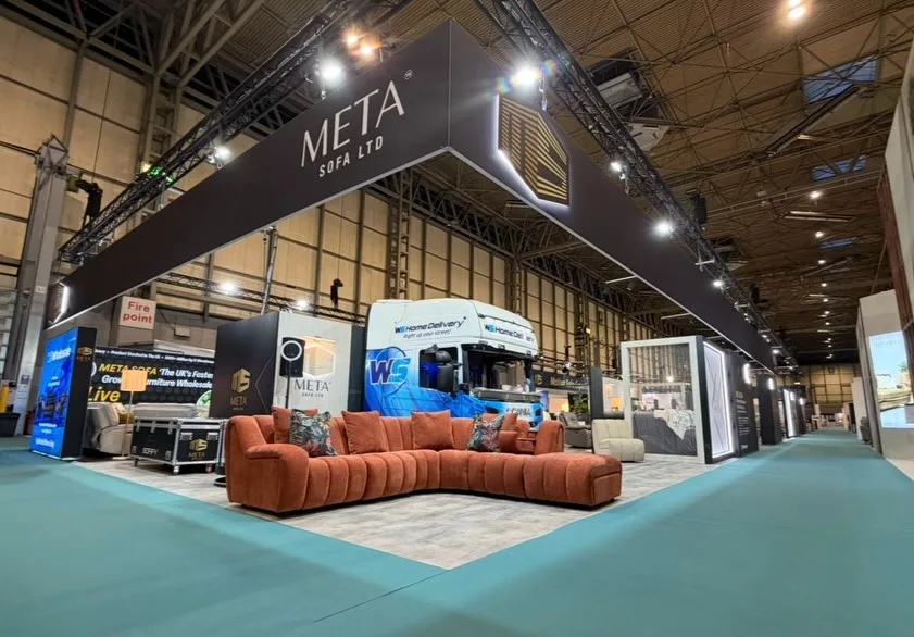 Wide view of the exhibition hall showing the scale of the Meta Sofa stand